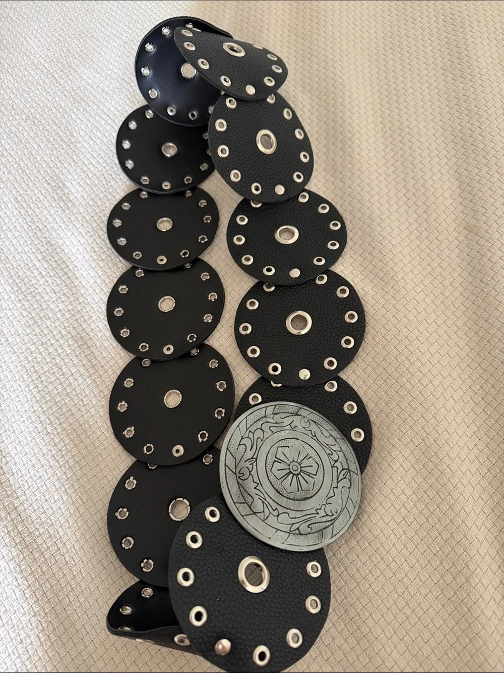 Black Eyelet Disc Stretch Belt with Decorative Silver Medallion